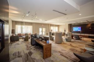 a lobby with a waiting room with chairs and a tv at Courtyard by Marriott Somerset in Somerset