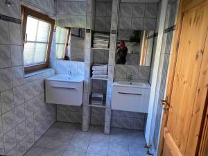 a bathroom with two sinks and a mirror at Ferien auf dem Eliesenhof in Welzheim +31 photos