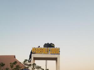 a sign for the backcountry humaneote on top of a building at Peacefully Resort in Dodoma