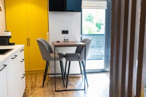 a kitchen with a small table and two chairs at Apartments DREAM in Málaga