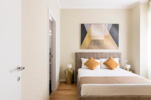 1 dormitorio con 1 cama y una pintura en la pared en Heart Milan Apartments Sforza Duomo, en Milán