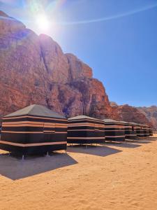 a row of buildings in front of a mountain at Star City Camp wadirum in Wadi Rum