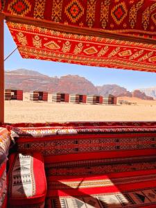 a view of a desert with mountains in the background at Star City Camp wadirum in Wadi Rum