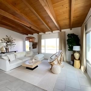 a living room with white furniture and a wooden ceiling at View Joshua Tree from the Desert D-LUX in Twentynine Palms