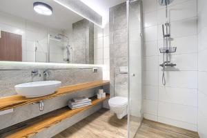 a bathroom with a sink and a toilet and a shower at Azyl Widoki in Wielkie Leżno