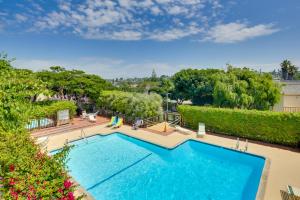 an overhead view of a swimming pool with trees and bushes at Stunning Solana Beach Condo with Community Pools! in Solana Beach