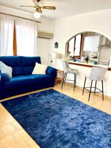 sala de estar con sofá azul y alfombra azul en Apartment VillaMartin Plaza - The Loft, en Orihuela Costa