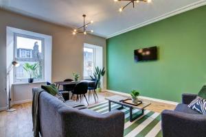 a living room with two couches and a table at The Annick - Coorie Doon Apartments in Irvine