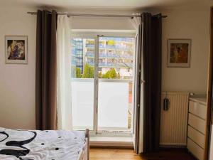 a bedroom with a large window and a bed at Wien an Donau in Vienna