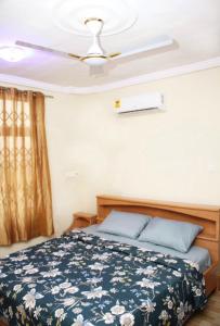 a bedroom with a bed and a ceiling fan at CNC Rehoboth Villa in Accra