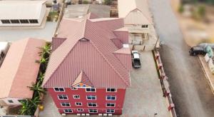 an overhead view of a red building with a roof at CNC Rehoboth Villa in Accra