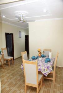 a dining room with a table and chairs at CNC Rehoboth Villa in Accra