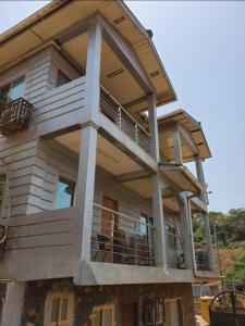 a house with a large balcony on top of it at Victorus Homes in Freetown