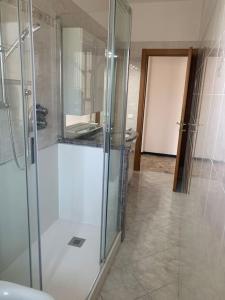 a glass shower in a bathroom with a sink at Vista mare con ogni comfort in Varazze