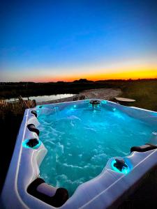 a hot tub with a view of the sunset at Høloftet bb in Esbjerg