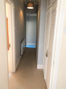 a hallway with a hallway leading into a room at Spacious West London 2 Bedroom Apartment in London