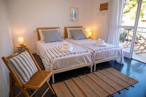 a bedroom with a large bed and a chair at [Penthouse with Terrace] • Sea 5Min • Trains 4Min in Varazze