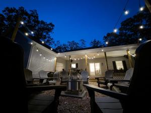 a patio with chairs and lights at night at Season 4 Escape - Managed by Gr8Escapes in Massanutten