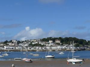 a group of boats sitting on the sand on the beach at The Commodore Hotel in Instow