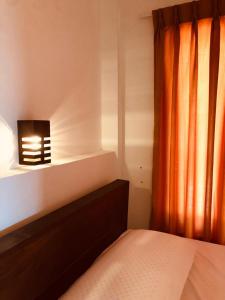 a bedroom with a bed and a window with a light at Nature Rock Dambulla in Dambulla