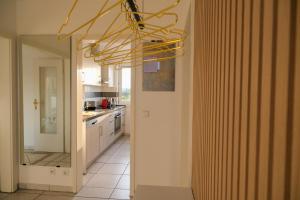a kitchen with a yellow chandelier in a room at Vesteblick-Penthouse in Coburg