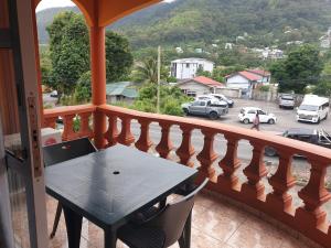 a balcony with a table and a view of a parking lot at Palmont Commercial Self-Catering Apartments - Beau Vallon in Beau Vallon