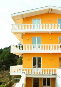 an orange building with a balcony at Snežna Kraljica in Sutomore