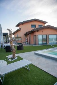 a house with a patio and a swimming pool at IL FIORE DI SPINA in Spina