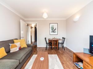 a living room with a couch and a table at Pass the Keys Sidney Street Lovely one bed flat - great base to explore London in London