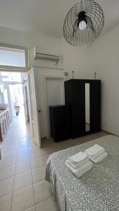 a bedroom with a bed with two towels on it at Casa Myda in Bari
