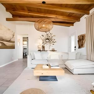 a living room with white furniture and a wooden ceiling at View Joshua Tree from the Desert D-LUX in Twentynine Palms