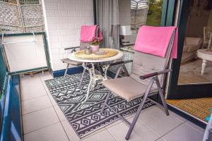 two chairs and a table on a patio at Schwalbennest - Hundefreundlich, Sauna, Pool, Dachterrasse, See & Natur in Möhnesee