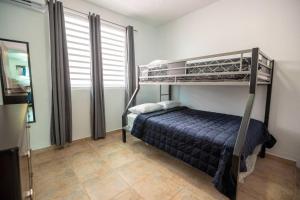a bedroom with two bunk beds and a mirror at 3 Santurce 2 Bedroom 1Bathroom Apt in San Juan