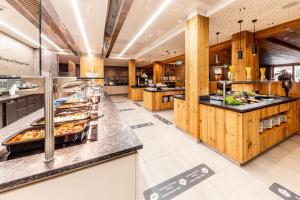 a large kitchen with a lot of food at Das Bayrischzell Familotel Oberbayern in Bayrischzell