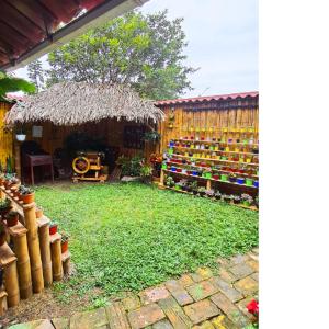 a yard with a garden with a store of flowers and plants at La Molienda Casa Hotel in San Agustín