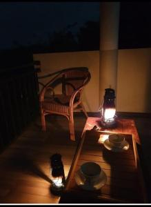 una mesa y un banco en un porche por la noche en Desire Village Rakwana, en Rakwana