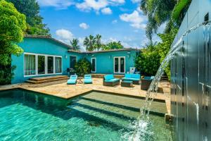 a swimming pool with a fountain in front of a house at #1 Fort Lauderdale House - Heated Salt Water Pool - Private Oasis-Updated Gorgeous 3BR 3BA - Las Olas in Fort Lauderdale