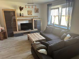 a living room with a couch and a tv at Monteurzimmer Rochau in Rochau
