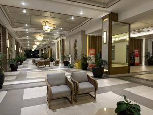 a lobby with chairs and plants in a building at Celandine Residence by DMCI in Manila