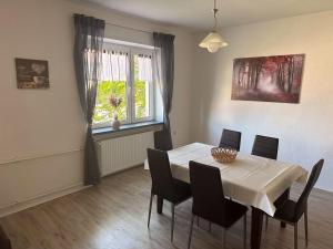 a dining room with a white table and chairs at Monteurzimmer Rochau in Rochau