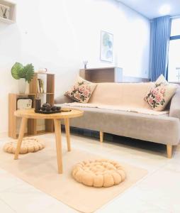 a living room with a couch and a table at Lakeview apartment - 5 minutes to Westlake - 20' to Noi bai airport in Hanoi