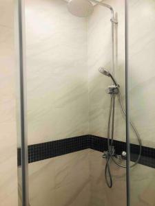 a shower with a glass door in a bathroom at Lakeview apartment - 5 minutes to Westlake - 20' to Noi bai airport in Hanoi