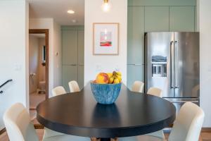 a dining room with a table with a bowl of fruit at Mini Marshmallow 30 Days minimum apts in Bend