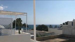 a view of the ocean from the roof of a house at Dar Blanche in Hammamet