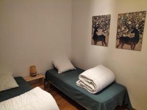 a room with two beds and two pictures on the wall at La Pradella Bolquere T3 PYRENEES 2000 in Bolquere Pyrenees 2000