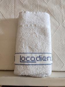 a white towel sitting on top of a shelf at Locadiera Pansion in Ermoupoli