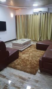 a living room with two couches and a couch at Victorus Homes in Freetown