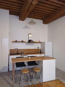 a kitchen with a wooden counter and two stools at Old town - Vieux Lyon -50 m2 flat in Lyon