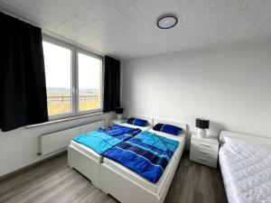a bedroom with a large bed and a window at Penthouse Brockenblick 381 in Braunlage