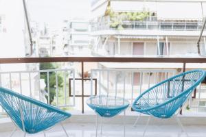 two blue chairs sitting on top of a balcony at Lavish condo in Athens Riviera in Athens +68 photos